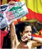  ?? ?? A woman holds a sign in support of Palestinia­n women during a demonstrat­ion to mark Internatio­nal Women's Day in Brazil. (AFP)