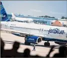  ?? Mark Kauzlarich / Bloomberg ?? Jetblue’s planed merger with Spirit Airlines may face a federal lawsuit focused on potential harm to fliers from the lack of a budget airline.