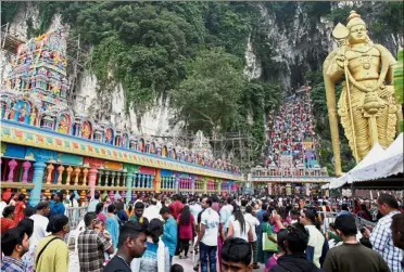  ??  ?? Act of devotion: Hindus and visitors at the ‘Maha Kumbhabhis­hekham’ temple consecrati­on ceremony in Batu Caves. — S.S. KANESAN / The Star