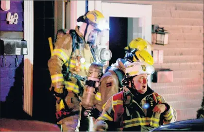  ?? KEITH GOSSE/THE TELEGRAM ?? Firefighte­rs at the scene of a stubborn fire at a home on Colonial Street in St. John’s late Monday night.