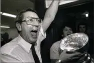  ?? THE ASSOCIATED PRESS ?? In this May 17, 1983, file photo, New York Islanders coach Al Arbour celebrates in the locker room as he holds the Stanley Cup after the team won their fourth cup. Arbour, who ranks as the NHL’s second-most winningest coach, has died, team officials...