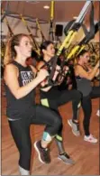  ?? MICHILEA PATTERSON — DIGITAL FIRST MEDIA ?? Women do resistance suspension training using TRX equipment during a class at the fitness studio TORQUE in Upper Providence. Participan­ts of TRX classes use their own body weight as part of their workout.