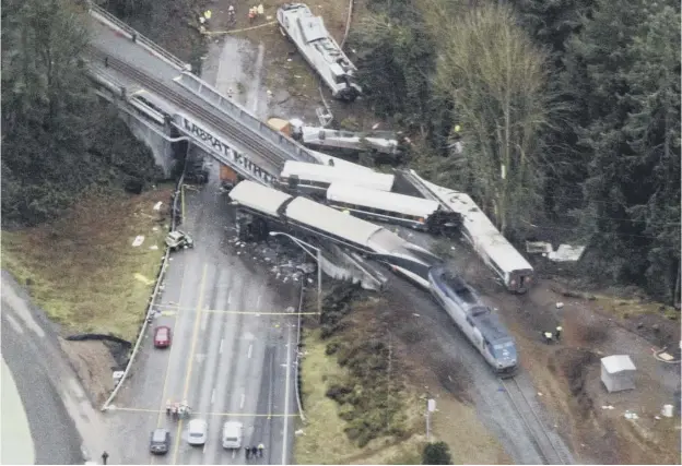  ??  ?? 0 A train that derailed on to an interstate motorway south of Seattle was travelling about 80mph in a 30mph zone. At least three people were killed in the crash