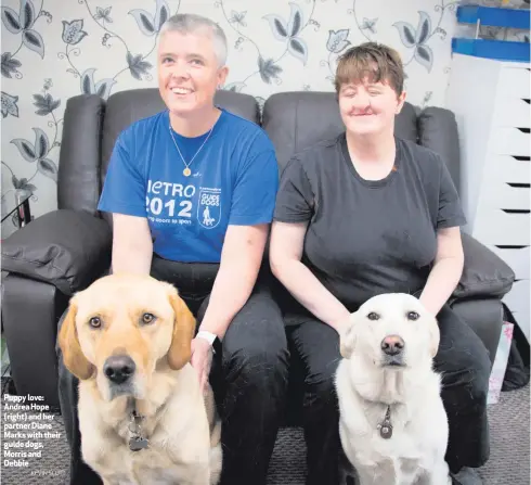  ?? KEVIN SCOTT ?? Puppy love: Andrea Hope (right) and her partner Diane Marks with their guide dogs, Morris and Debbie