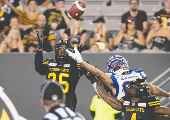  ?? PETER POWER/THE CANADIAN PRESS FILES ?? TSN is set to ensure it’s the home of all CFL plays, like Hamilton Tiger-Cats defensive back Jumal Rolle snatching an intercepti­on against the Winnipeg Blue Bombers, through 2025.