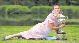  ?? AFP ?? Aryna Sabalenka poses with the Australian Open trophy in Royal Botanic Gardens in Melbourne.