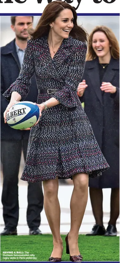  ??  ?? HAVING A BALL: The Duchess demonstrat­ed nifty rugby skills in Paris yesterday