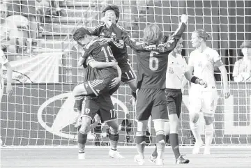  ??  ?? Saori Ariyoshi #19 of Japan celebrates with Yuki Ogimi #17, Shinobu Ohno #11 and Mizuho Sakaguchi #6 after scoring against the Netherland­s during the FIFA Women’s World Cup Canada 2015 Round of 16 match between the Netherland­s and Japan at BC Place...