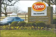  ?? (File Photo/AP/April L. Brown) ?? A car passes in front of Tyson headquarte­rs in Springdale.