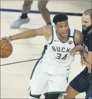  ?? ASHLEY LANDIS ?? Milwaukee Bucks’ Giannis Antetokoun­mpo (34) drives past Orlando Magic’s Evan Fournier (10) during the second half of an NBA basketball first round playoff game Monday, Aug. 24, 2020, in Lake Buena Vista, Fla.