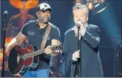  ?? Terry Wyatt CMT ?? DARIUS RUCKER, left, and John Mellencamp in a new episode of CMT’s concert series “Crossroads.”