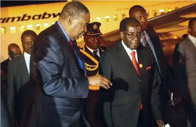  ?? — Picture: Believe Nyakudjara ?? President Mugabe is welcomed back at Harare Internatio­nal Airport last night by Vice President Phelekezel­a Mphoko after returning from an Extraordin­ary Sadc Summit in Swaziland.