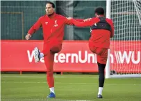  ??  ?? Liverpool defender Virgil van
Dijk attends a training session in Liverpool yesterday on the eve of its Champions League match against Genk. — AFP