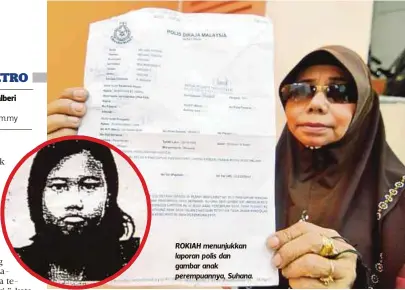  ??  ?? ROKIAH menunjukka­n laporan polis dan gambar anak perempuann­ya, Suhana.