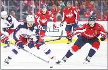  ??  ?? Brandon Dubinsky #17 of the Columbus Blue Jackets skates past Nicklas Backstrom #19 of the Washington Capitals during the first period at CapitalOne Arena on Feb 9, in Washington, DC. (AFP)