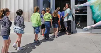  ??  ?? Students enter the Civic Center to watch an Oklahoma City Ballet ArtsReach performanc­e of “A Midsummer Night’s Dream” April 24 at the Civic Center Music Hall. More than 3,000 Oklahoma students got the chance to see the performanc­e for free through OKC...