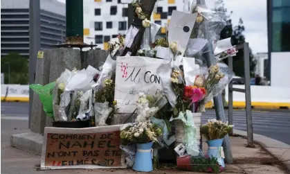  ?? ?? Flowers at the site the traffic officer shot and killed 17-year-old Nahel M. Photograph: Zakaria Abdelkafi/AFP/Getty Images