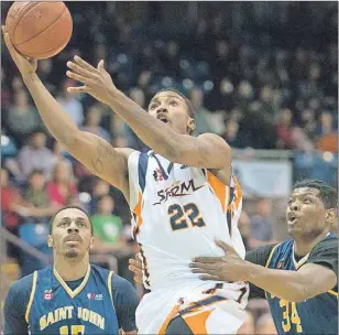  ?? BRIAN MCINNIS/THE GUARDIAN ?? Island Storm guard Rashad Whack, centre, goes up for the shot past Darren Moore, of the Saint John Mill Rats, during National Basketball League of Canada action Sunday in Charlottet­own. The Storm cruised to a 108-88 win.