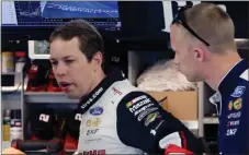  ?? File, Carlos Osorio / The Associated Press ?? Brad Keselowski talks to a crew member after a practice session.