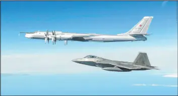  ?? North American Aerospace Defense Command file ?? A Russian Tu-95 bomber, top, is intercepte­d by a U.S. F-22 Raptor off the Alaska coast. The Air National Guard has delayed personnel changes in Alaska until September 2025 that could threaten national security and civilian rescue missions.