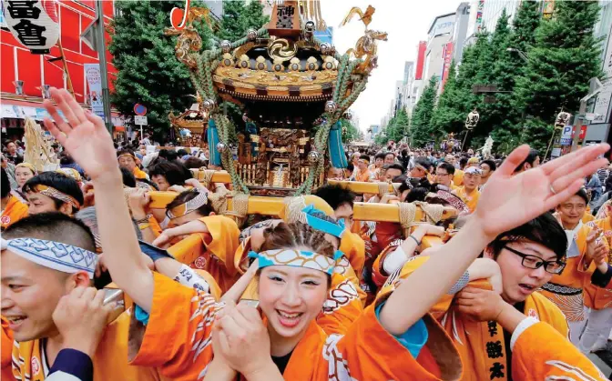  ??  ?? Festival participan­ts parade with a portable shrine through the precincts of Kanda Myojin shrine during the annual Kanda Myojin Festival in Tokyo, yesterday.—AP