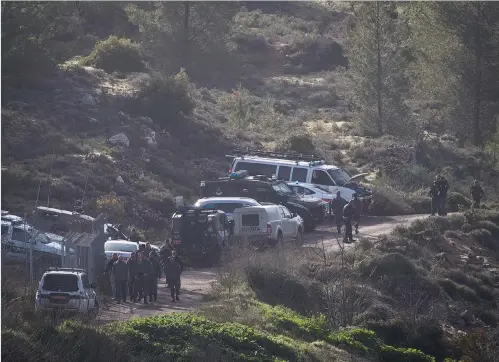  ?? (Yonatan Sindel/Flash90) ?? SECURITY FORCES search the scene on Thursday where the body of Ori Ansbacher was found in Jerusalem’s Ein Yael forest.