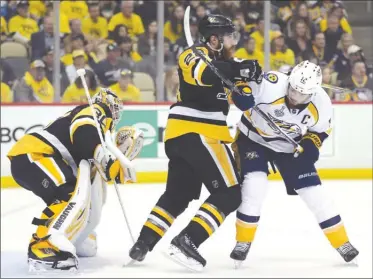  ?? The Associated Press ?? Pittsburgh Penguins defenceman Ian Cole checks Nashville Predators captain Mike Fisher in front of Penguins goaltender Matt Murray during Game 2 of the Stanley Cup Final in Pittsburgh on Wednesday.