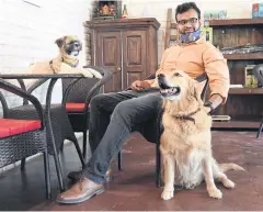  ??  ?? Avani Naresh, 29, spends time with therapy dogs at the Fur Ball Story dog cafe in Gurgaon outside of New Delhi.