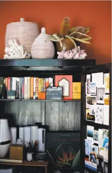  ??  ?? Dried botanicals, above, and coral adorn the top of the armoir in Nolan’s home office. A designer at Flora Grubb, Nolan lives in San Francisco. Left: The dining room spotlights Anthurium plowmanii on the dining-room table — as showy as any floral...