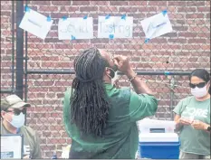  ?? FREDERIC J. BROWN — AFP VIA GETTY IMAGES ?? A man takes a COVID-19 test at a Skid Row community outreach event where COVID-19 vaccines and testing were offered in Los Angeles on Monday.