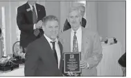  ??  ?? Doug Walker / RN-T
Kevin Ayers (left), 2018 president of the Greater Rome Board of Realtors, presents the Hall of Fame plaque to Hardy Realty CEO Jimmy Byars.