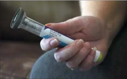  ?? RICK BOWMER - THE ASSOCIATED PRESS FILE PHOTO ?? In this July 11 file photo, Bridgett Snelten holds her Trulicity injection at her home in Sandy, Utah. Snelten has diabetes and has had to change health insurance plans three years in a row. Twice, new insurers wouldn’t cover Trulicity, a once-a-week injected diabetes medicine she’d been taking that helped control her blood sugar tightly.