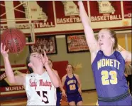  ?? RICK PECK/SPECIAL TO MCDONALD COUNTY PRESS ?? McDonald County’s Ragan Wilson drives past Monett’s Kaesha George for a layup during the Lady Mustangs’ 55-36 win on Feb. 23 at MCHS.