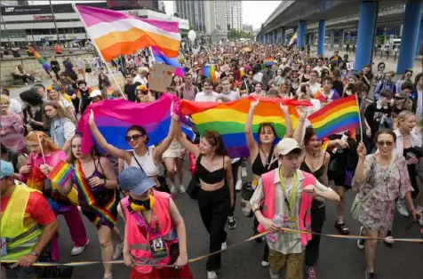  ?? Associated Press ?? Marchers take part in Poland's yearly Pride parade, known as the Equality Parade, in Warsaw on June 17. This year's event was dedicated to transgende­r rights, which are facing a backlash in many countries.