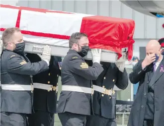  ??  ?? Shane Cowbrough, father of Sub-Lt. Abbigail Cowbrough, wipes away tears as pallbearer­s carry his daughter’s casket during Wednesday’s repatriati­on ceremony at CFB Trenton.