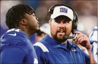  ?? Vera Nieuwenhui­s / Associated Press ?? Giants coach Brian Daboll talks with Azeez Ojulari during Sunday’s preseason game against the Bengals.