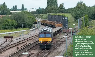  ??  ?? GB Railfreigh­t 66746 departs March Whitemoor Yard on July 13, crossing the junction with the Wisbech line which could reopen in around eight years, subject to Government approval.