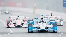  ?? NATHAN DENETTE/THE CANADIAN PRESS ?? IndyCar points leader Juan Pablo Montoya of Colombia takes a corner during his practice run as rain hampered the Toronto Indy on Friday.