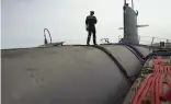  ?? ?? A crewman walks along the top of one of France's Rubis-class submarines