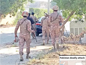  ??  ?? Paramilita­ry forces and police are seen during an attack on the Chinese consulate, where blasts and shots are heard, in Karachi, Pakistan. — Reuters photo