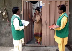  ?? AFP ?? Bureau of Statistics officials collect informatio­n from a Christian woman during a census drive in the Youhanabad area of Lahore. —