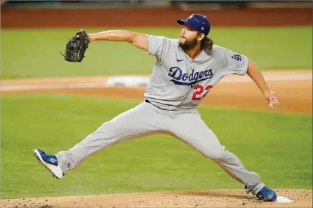  ?? The Associated Press ?? L.A. Dodgers pitcher Clayton Kershaw throws against the Atlanta Braves during Game 4 of the National League Championsh­ip Series Thursday, in Arlington, Texas. Due to deadline restrictio­ns, a Game 1 score was not available from the World Series.