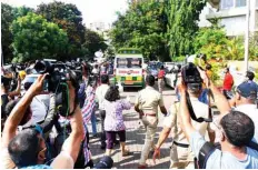  ??  ?? An ambulance (top center) carrying the body of Indian Bollywood actor Sushant Singh Rajput is seen leaving after he took his own life, near his residence in Mumbai on Sunday.