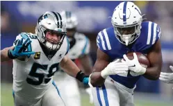  ?? Michael Conroy/Associated Press ?? ■ Indianapol­is Colts running back Marlon Mack (25) runs past Carolina Panthers’ Luke Kuechly (59) on Dec. 22, 2019, in Indianapol­is.