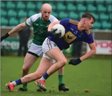  ??  ?? Wicklow’s Gearoid Murphy holds off the attention of Matt Moynihan.