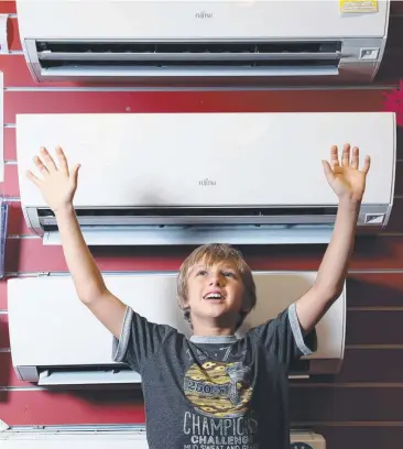  ??  ?? HEAVEN: Oliver Tudehope, 10, of Mossman, chills out at Harvey Norman Cairns. Picture: MARC McCORMACK