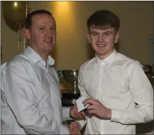  ??  ?? St Colmcille’s David Bell receives his Leinster MFC medal from county senior manager Andy McEntee at the underage presentati­on night in Navan O’Mahonys.