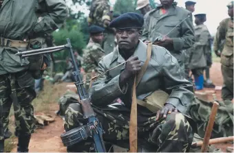  ??  ?? Rwandan Patriotic Front soldiers preparing to march into Kigali, Rwanda, 1994