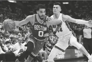  ?? LYNNE SLADKY/AP ?? BOSTON CELTICS FORWARD JAYSON TATUM (0) dribbles the ball as Miami Heat guard Tyler Herro (14) defends during the first half of Game 2 of the Eastern Conference finals playoff series on Thursday in Miami.