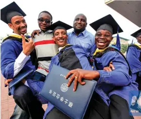  ??  ?? African students attend a graduation ceremony at the Tianjin University of Technology and Education in China’s Tianjin.